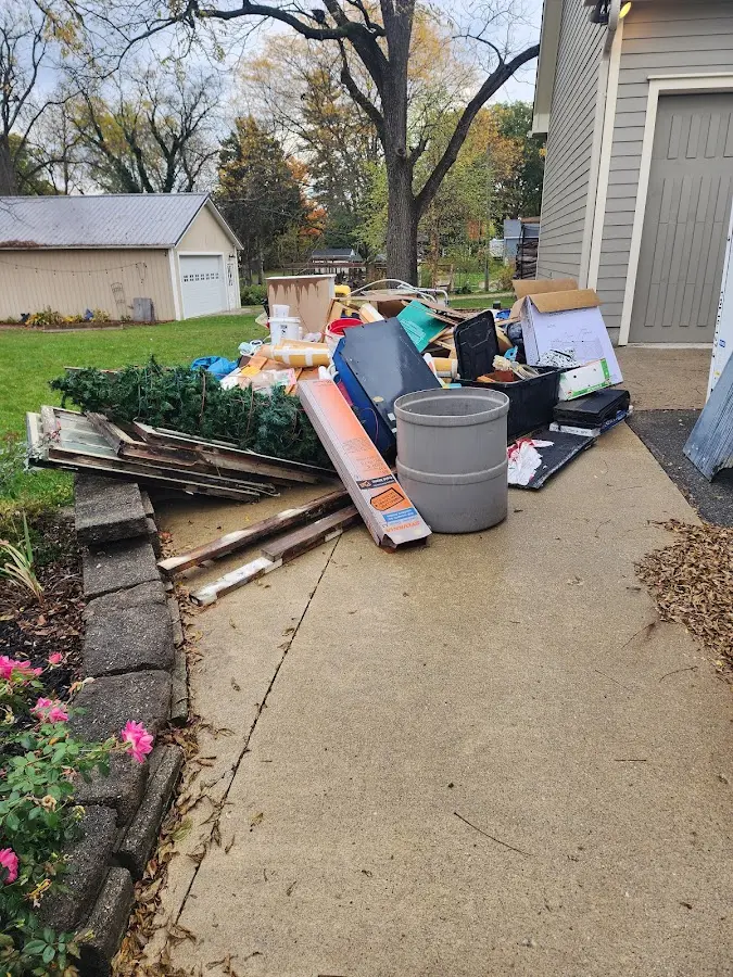 Dumpster being loaded with debris for Estate Cleanout Dumpster Rental in Fife
